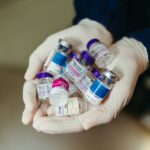 Gloved hands holding multiple vials of botulinum toxin treatments, including Botox and Daxxify, highlighting options for wrinkle reduction.